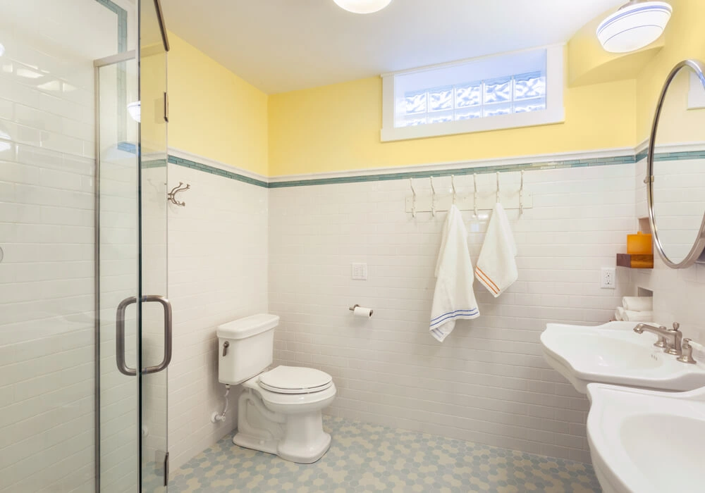 packers-themed-basement-14 - After – Custom tiling and dual pedestal sinks