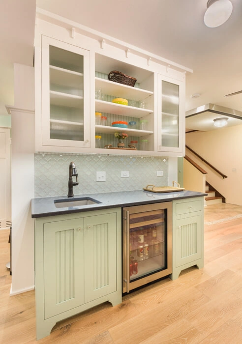 packers-themed-basement-2 - After – Wet bar with glass tile and painted cabinetry