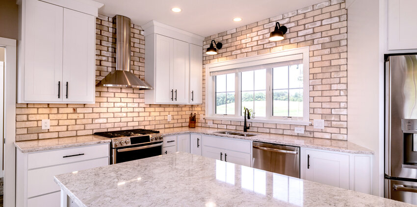 farmhouse style kitchen with brick backsplash