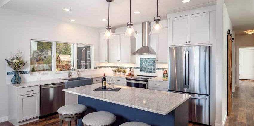 kitchen with quartz countertops and gray painted island