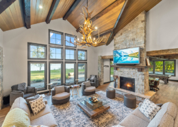 great room with vaulted tongue and groove ceiling and timber beams