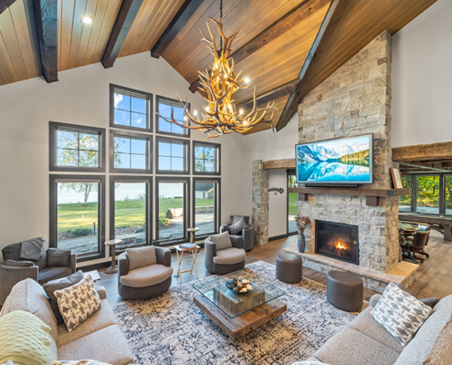 great room with vaulted tongue and groove ceiling and timber beams