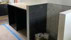 black laundry cabinets and black and white dog shower tile