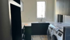 laundry room with black cabinetry