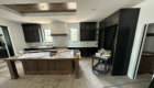 kitchen with tray ceiling and black cabinetry