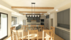 rendering of a farmhouse style kitchen with wood beams