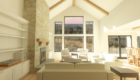 rendering of a farmhouse style great room with large window wall